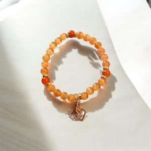 Orange cateye med rose berlocker
